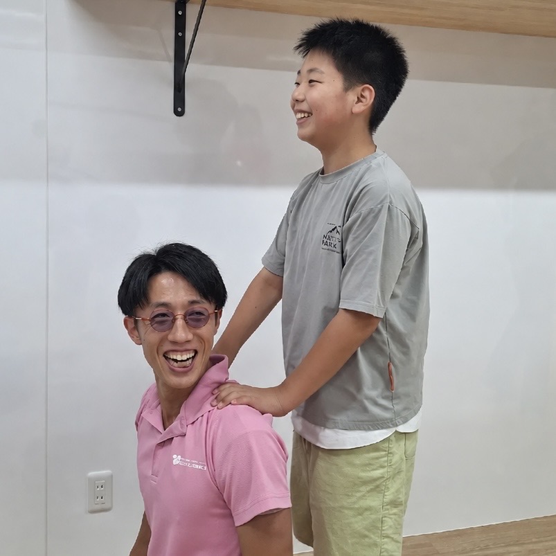 子どもと笑顔で関わる男性スタッフ